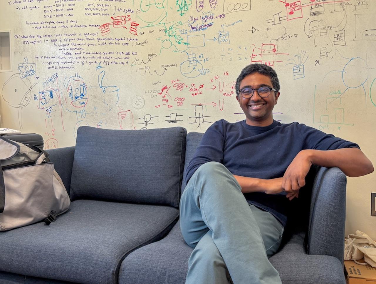 Kapil Ramachandran sitting on a sofa