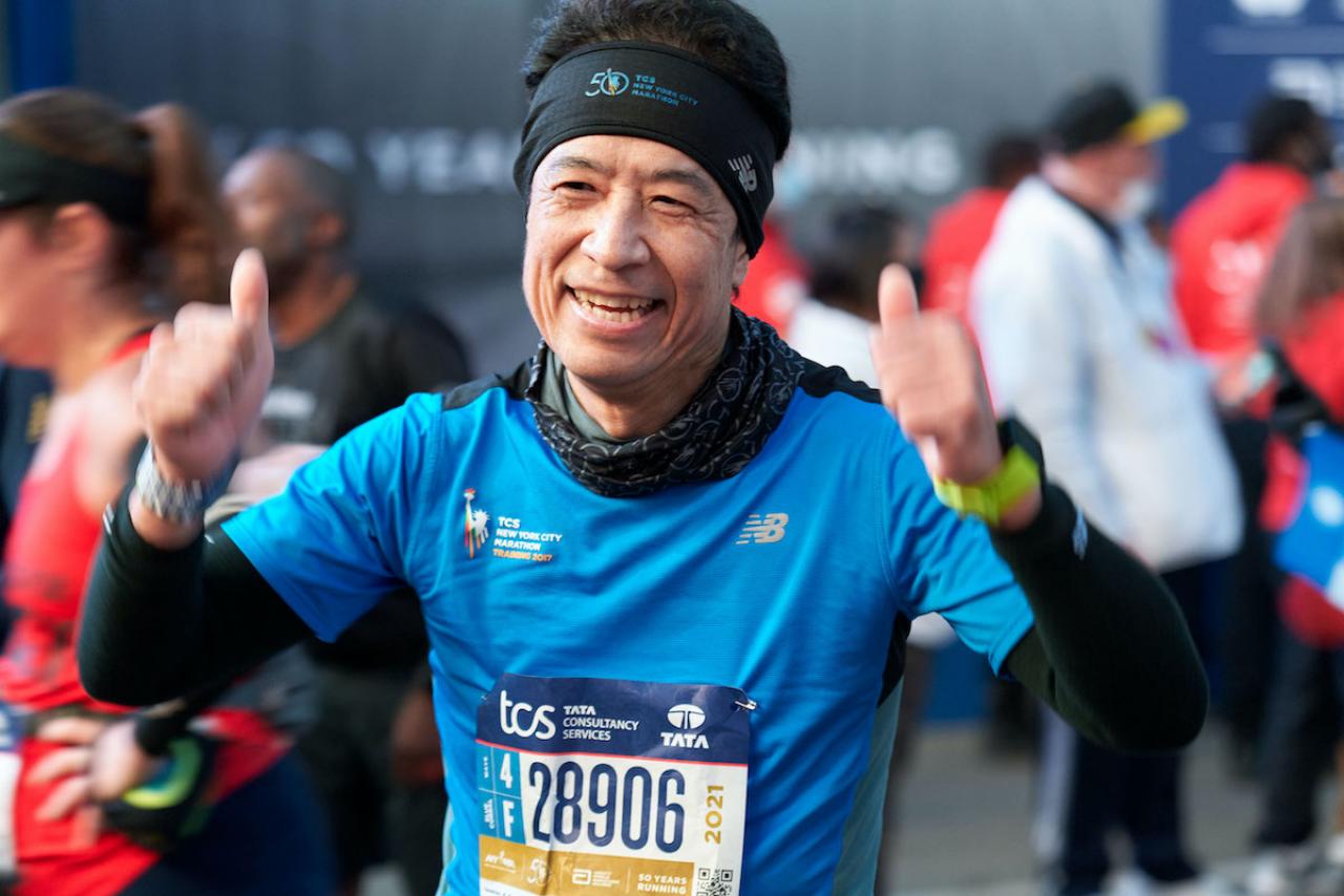 Columbia surgeon Tomoaki Kato celebrating at the finish line of the 2021 New York Marathon