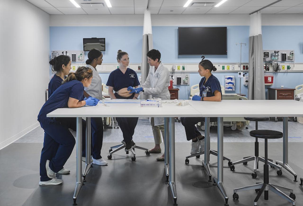 Columbia Nursing students with professor in the school's simulation center