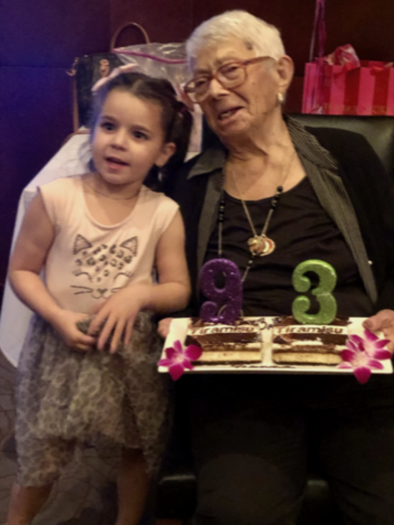 child standing next to her greatgrandmother