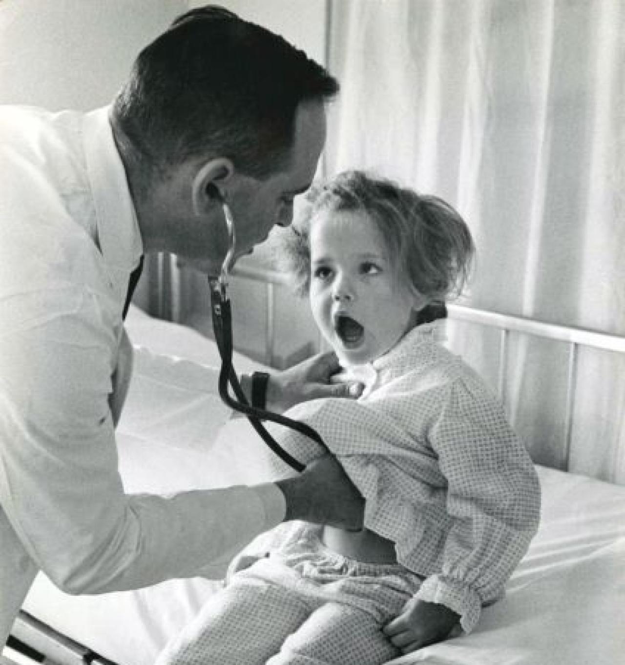 Dr. Herbert Cohen examines a young cystic fibrosis patient Doctor examining a young child
