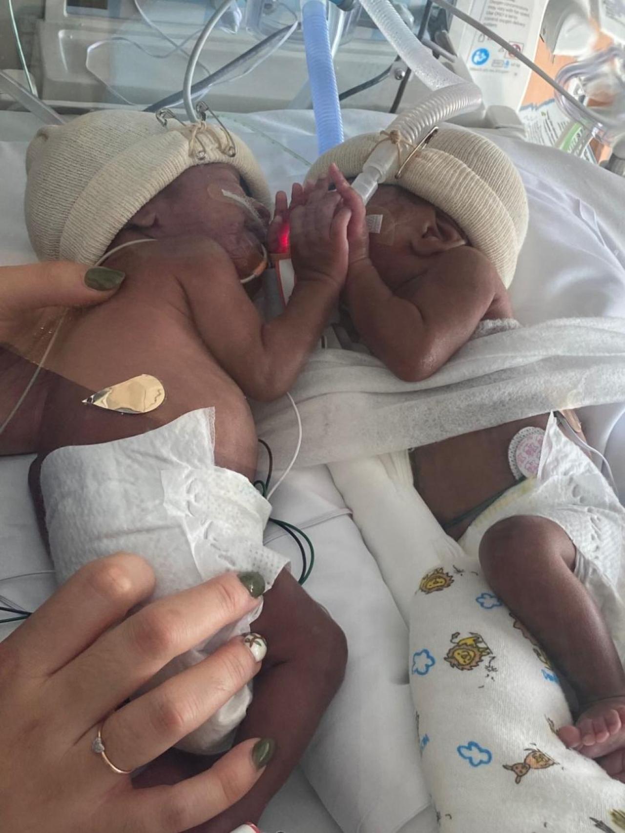 two premature babies in a neonatal intensive care bed