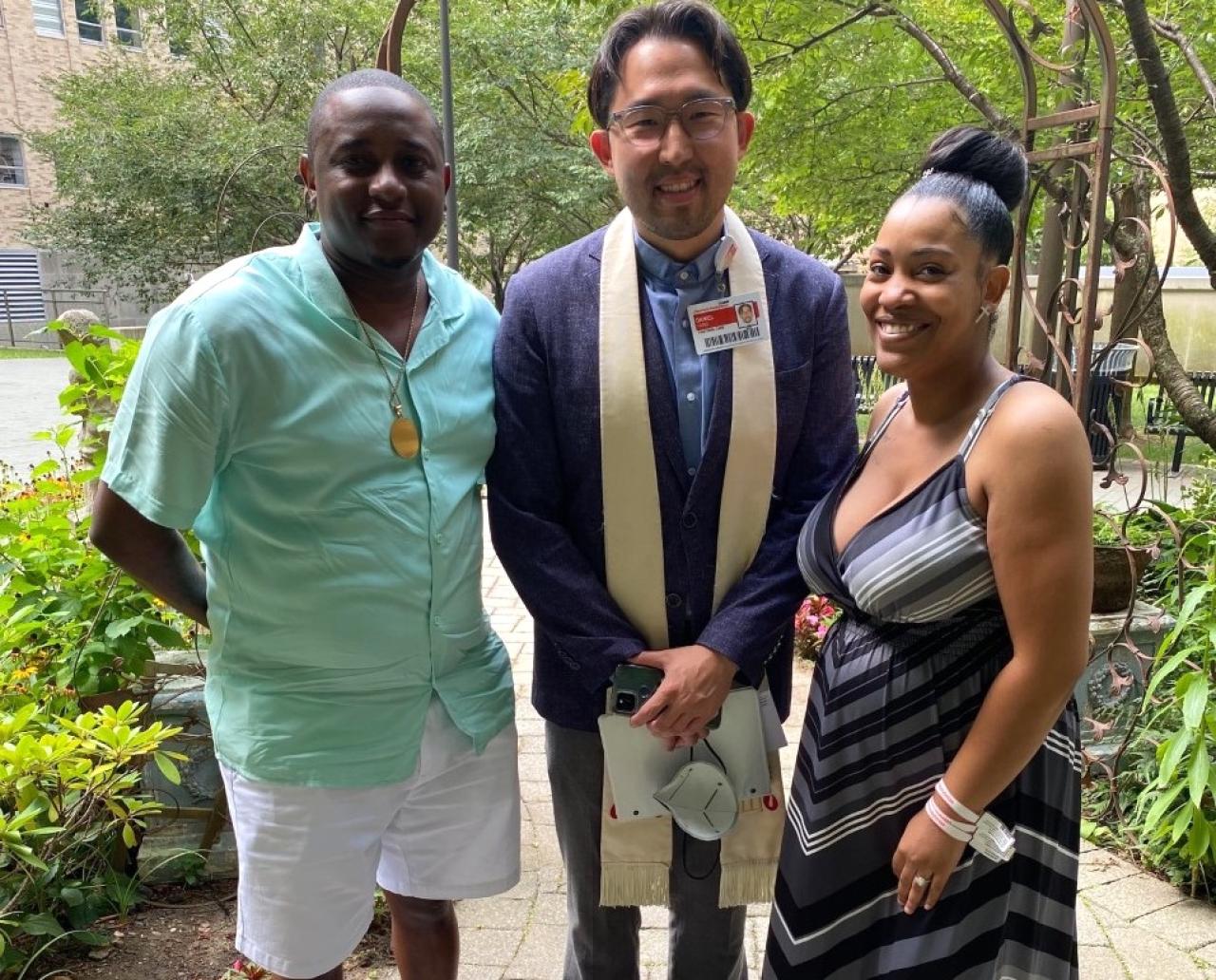 a man and woman stand next to a Reverend