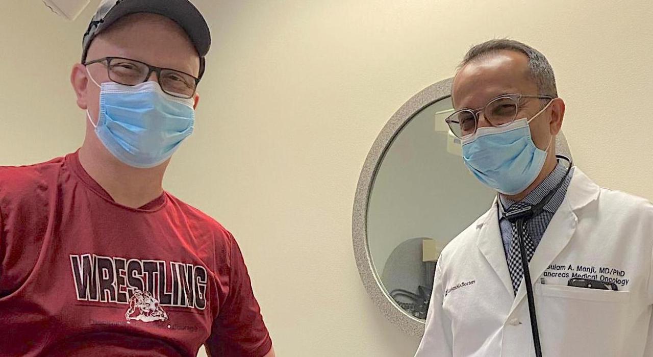 patient standing next to his physician