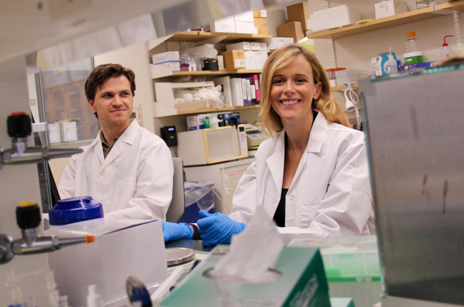 two scientists in lab coats at work in a laboratory