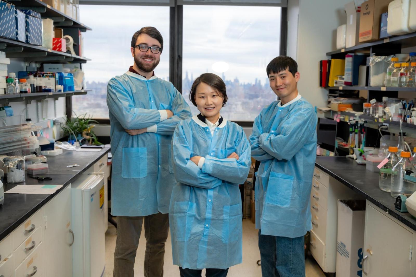 three people standing in a research laboratory