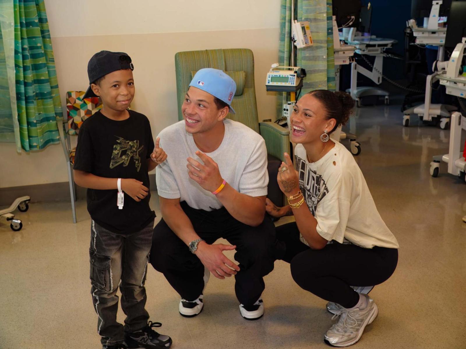 Ben Shelton and Trinity Rodman with a young cancer patient