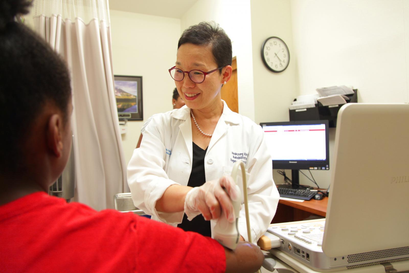 smiling doctor with a young patient