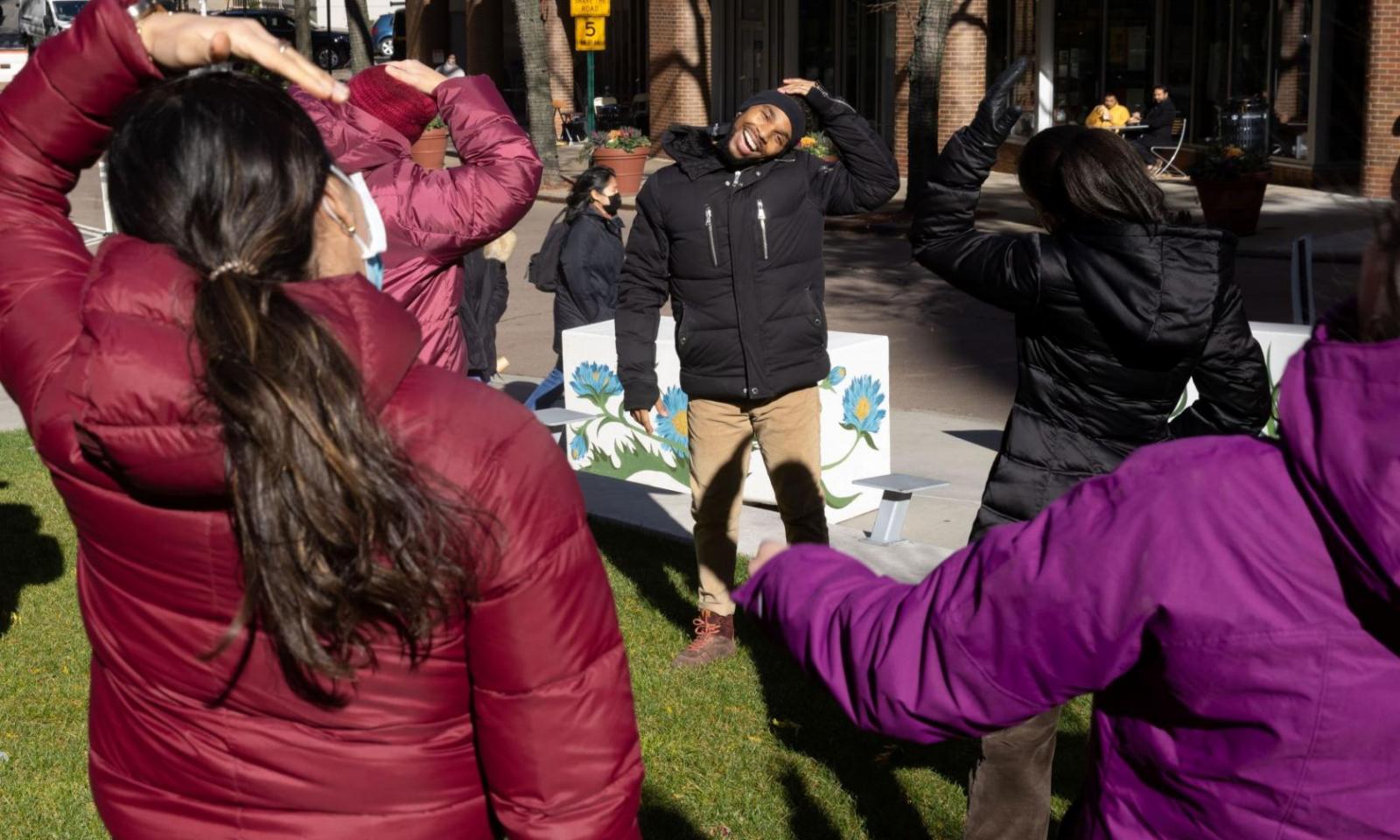 people stretching at outdoor exercise class