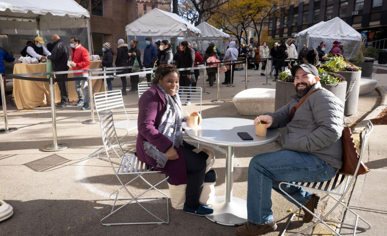 two people eating lunch at outdoor table