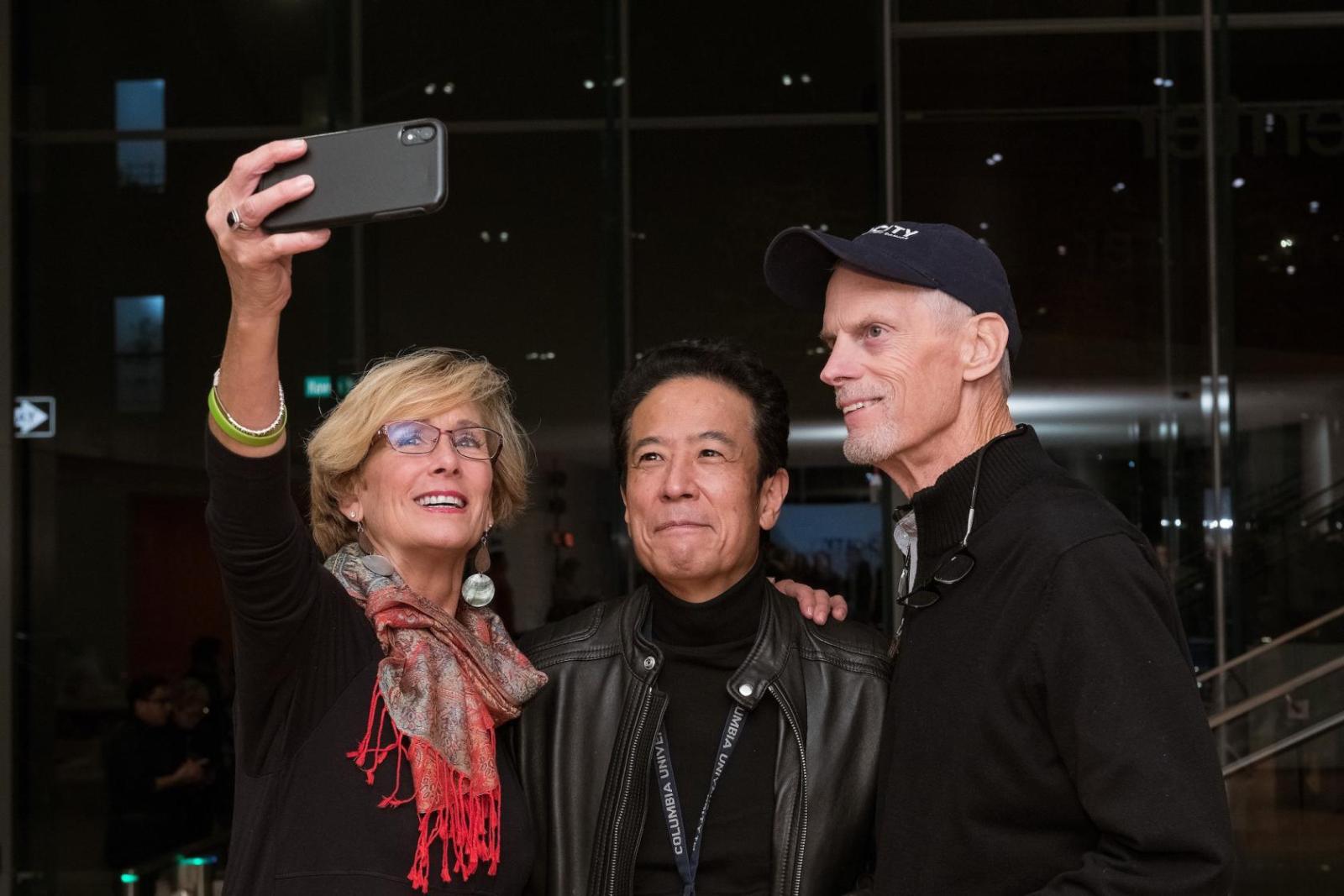 three people posing for a selfie
