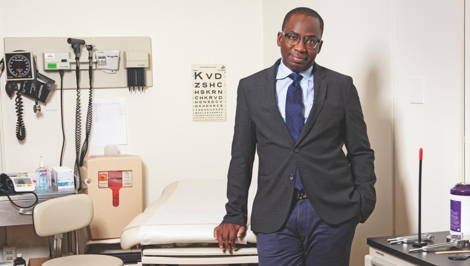 doctor in suit standing in a medical exam room