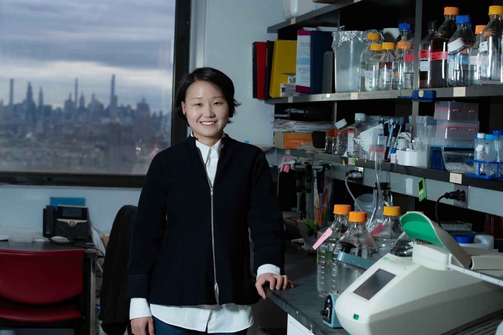 Hachung Chung, PhD standing next to her lab bench
