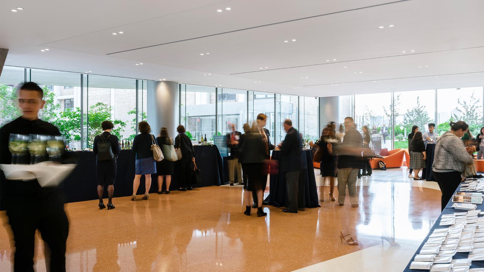 Attendees and staff during a reception in the VEC lobby.