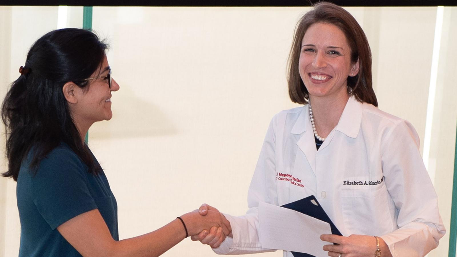 Elizabeth A. Scharle, MD (right), assistant professor of medicine at CUMC, received the Major Clinical Year Outstanding Teacher Award.