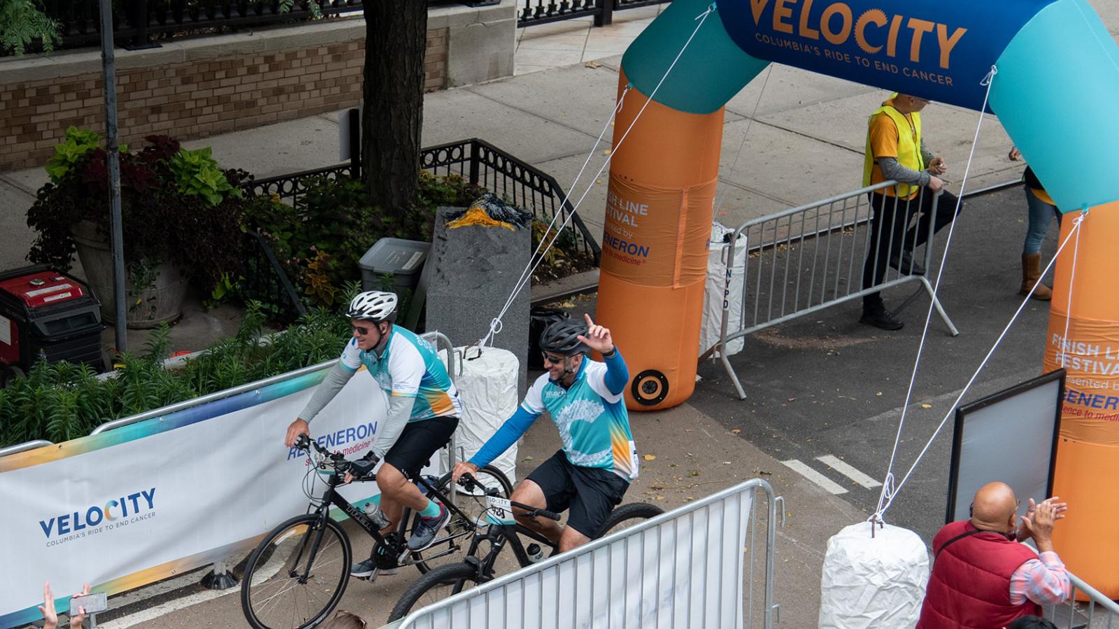 Velocity riders cross the finish line.