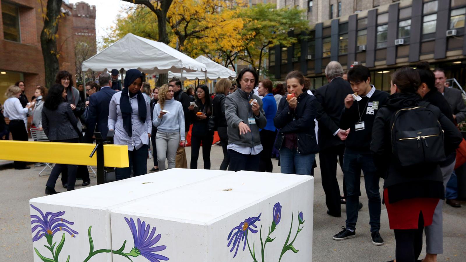 Members of the Columbia community and local residents of Washington Heights view public art at Welcome Haven, an event in Haven Plaza.