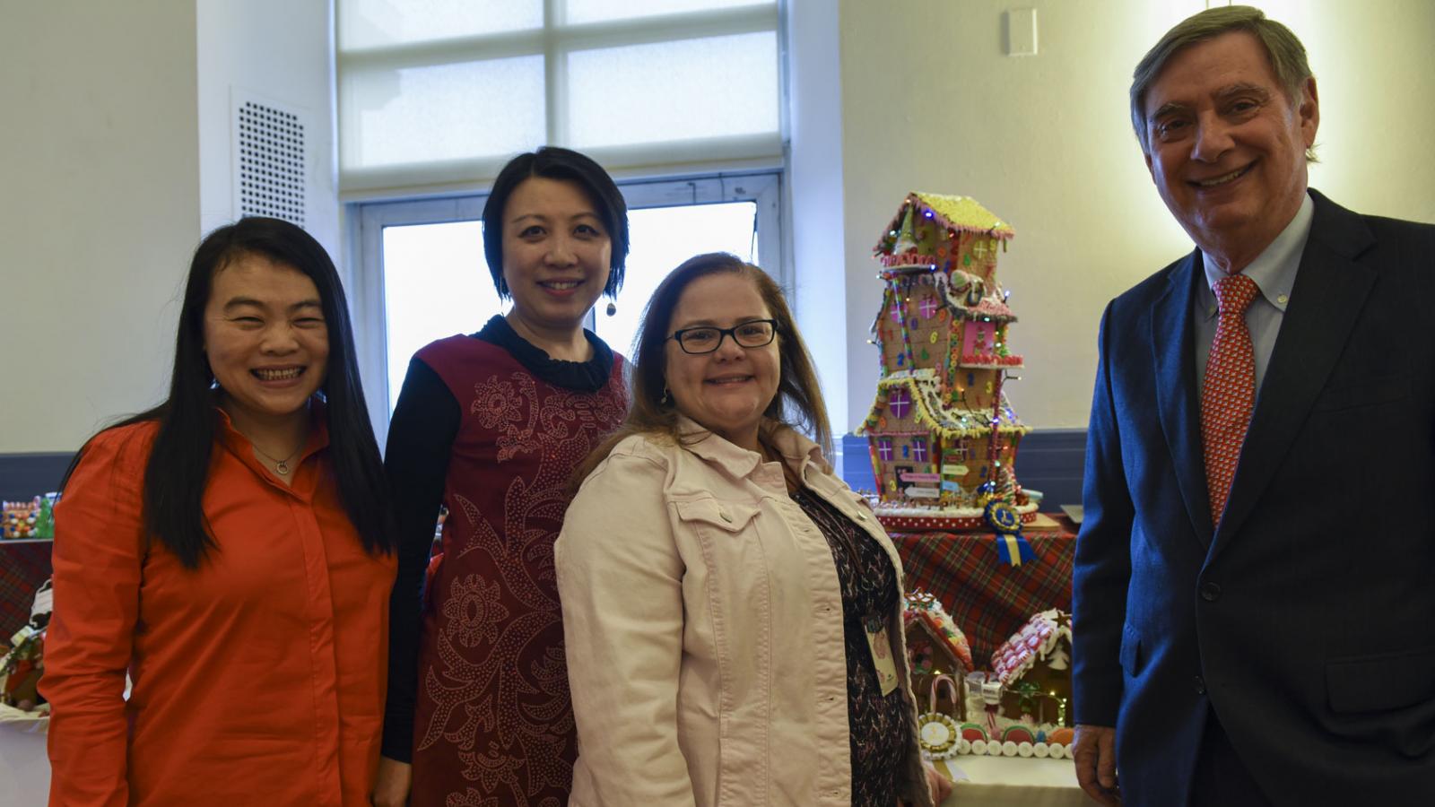 Dean Goldman is pictured with a member of the CUIMC Finance Office, which won 1st Place in a gingerbread house-making contest.