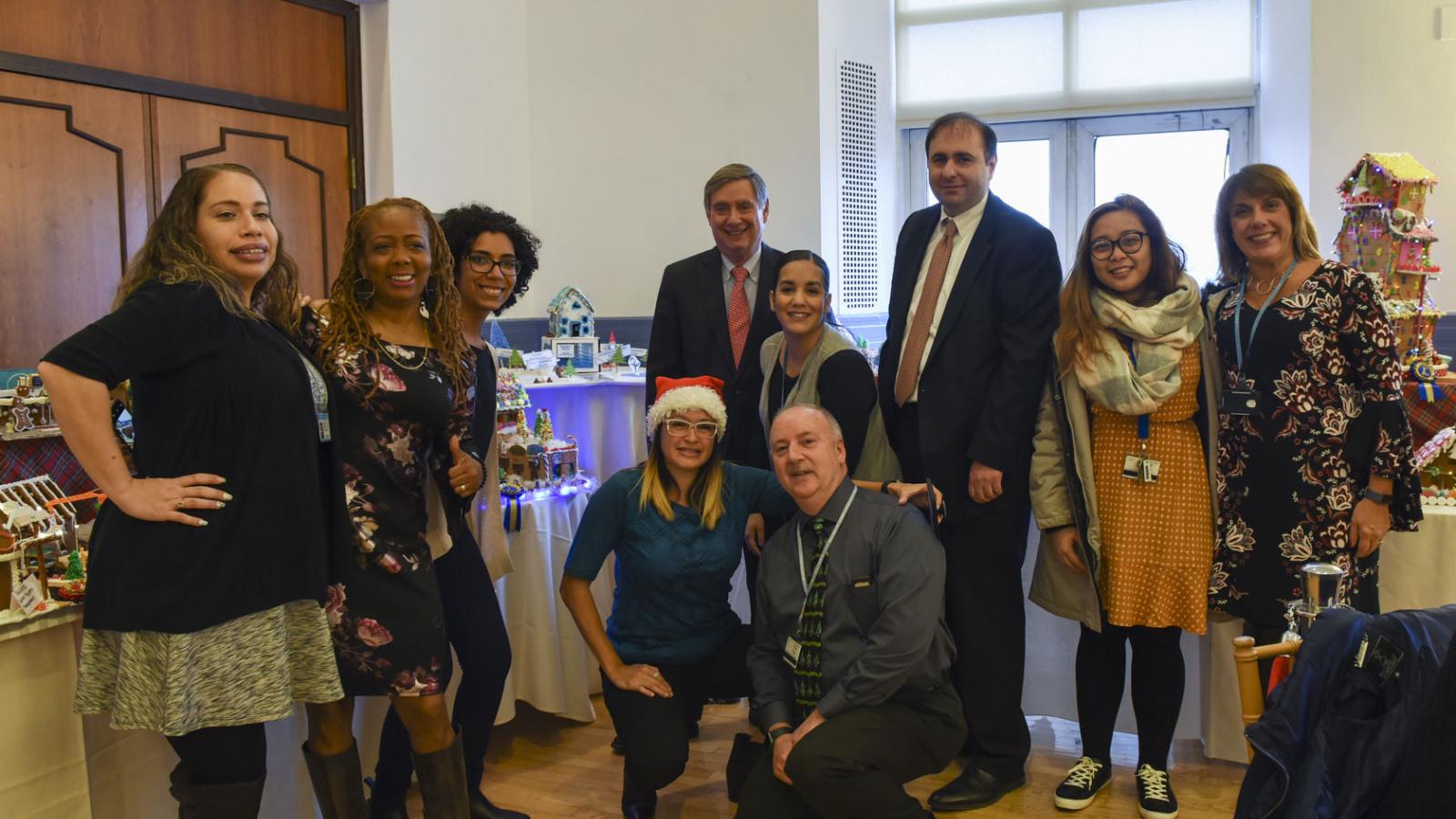 Dean Goldman is pictured with a member of the CUIMC Facilities – Finance team, which won 1st Place in a gingerbread house-making contest.