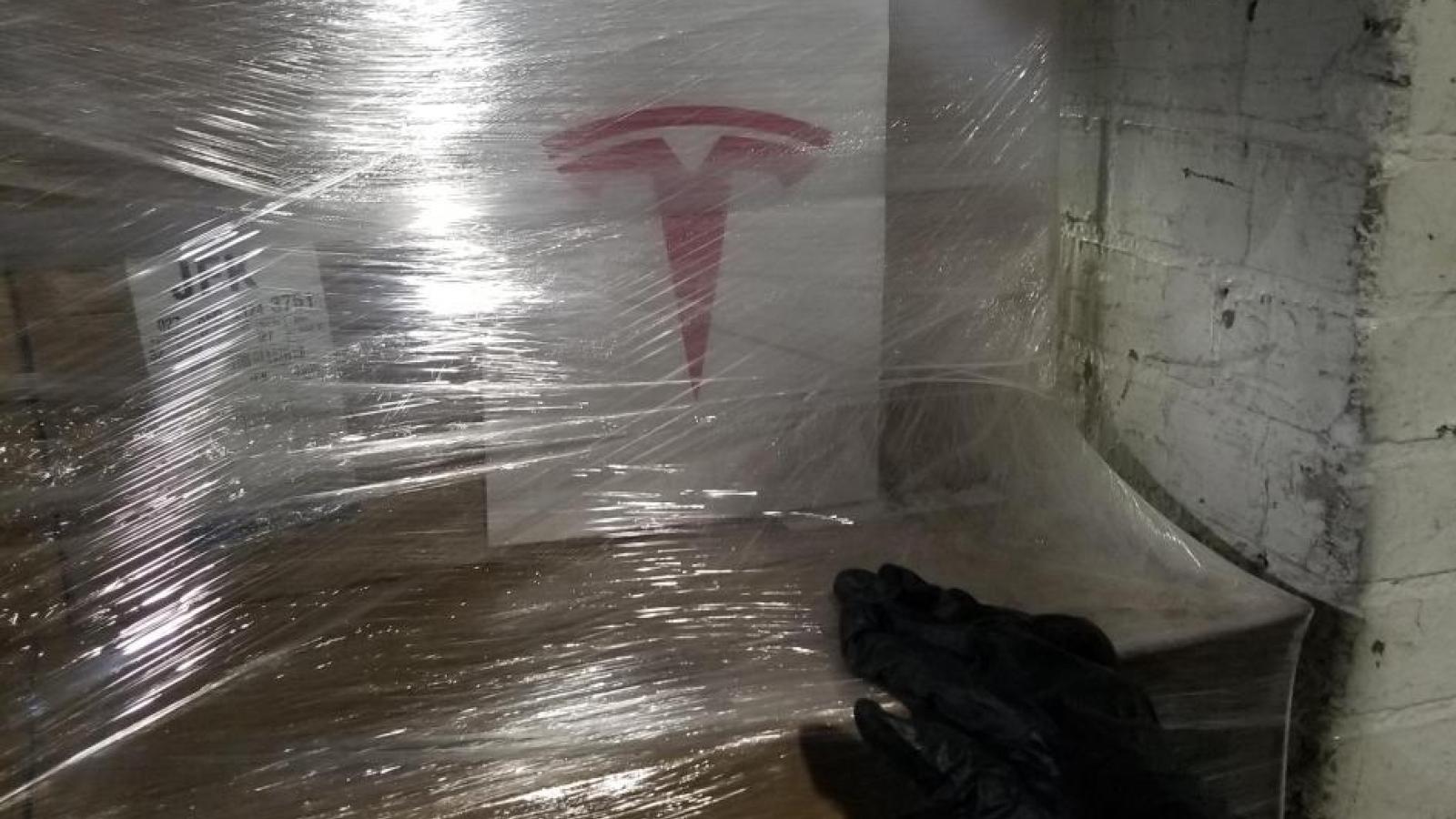 Boxes shrink wrapped with Tesla logo