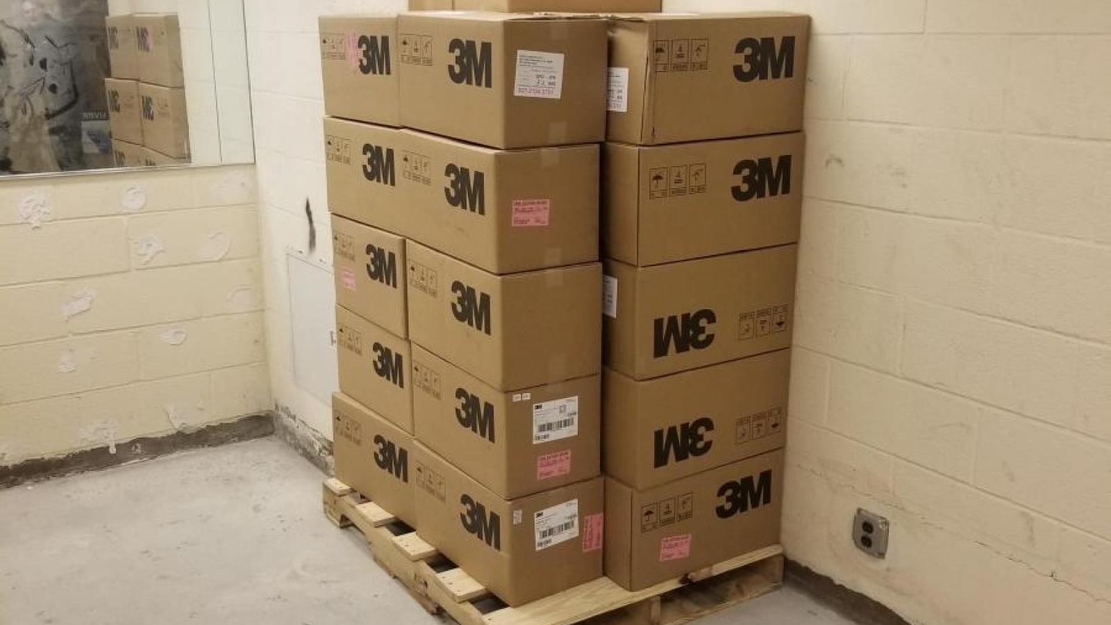 Stack of boxes labelled 3M containing face masks