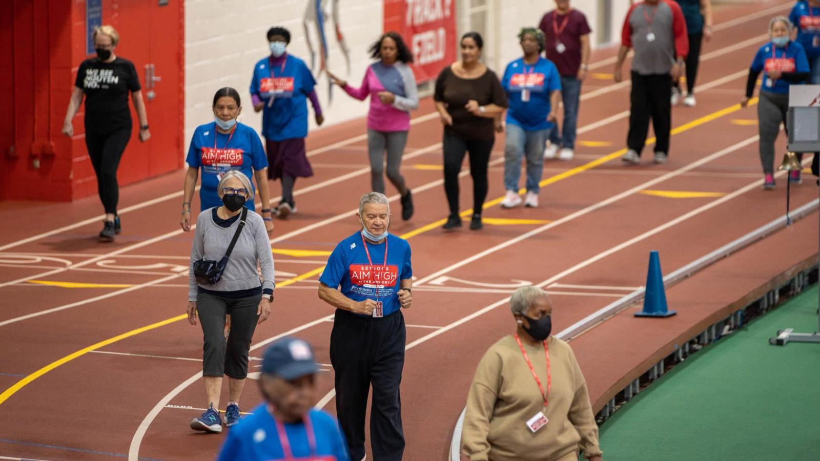 Participants walk and run around a track.