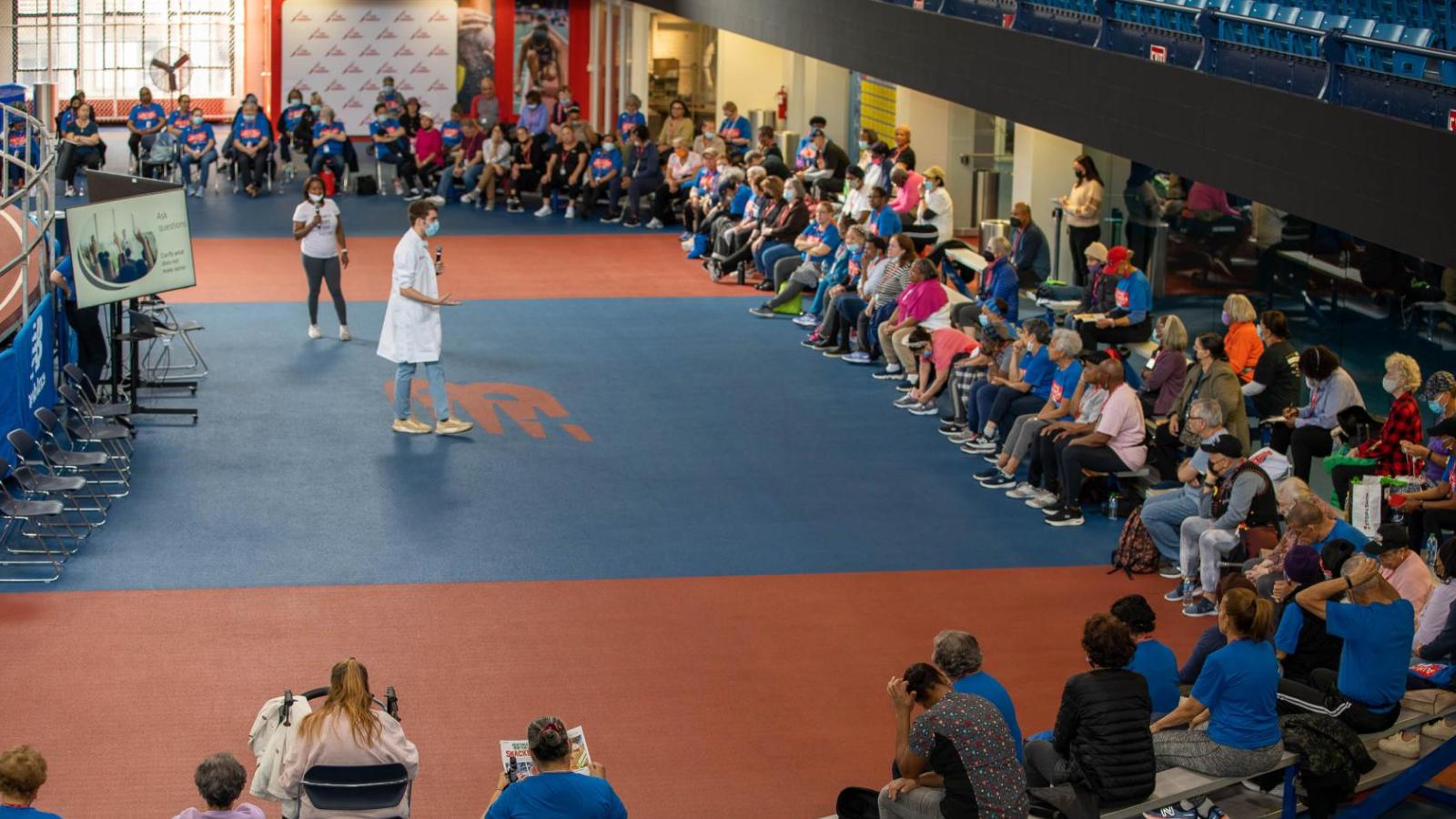 A doctor gives a presentation to seniors at a fitness program.