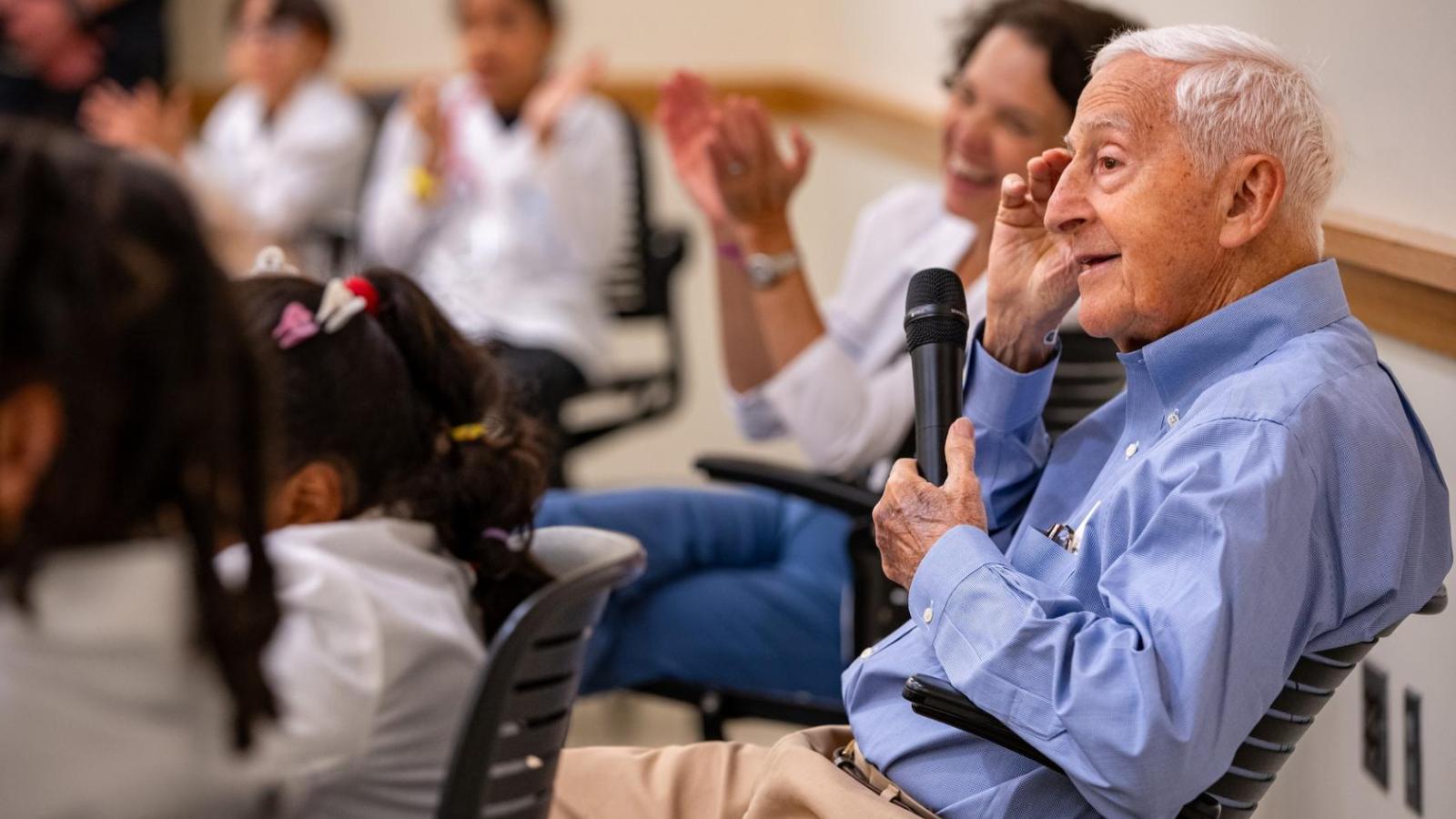 Roy Vagelos meeting schoolchildren in a classroom