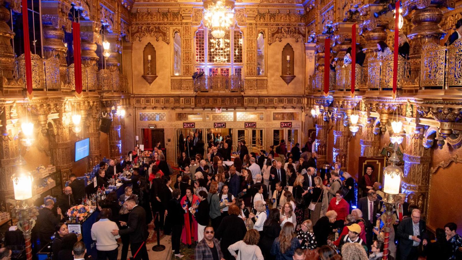 crowd of attendees in the lobby of a theater