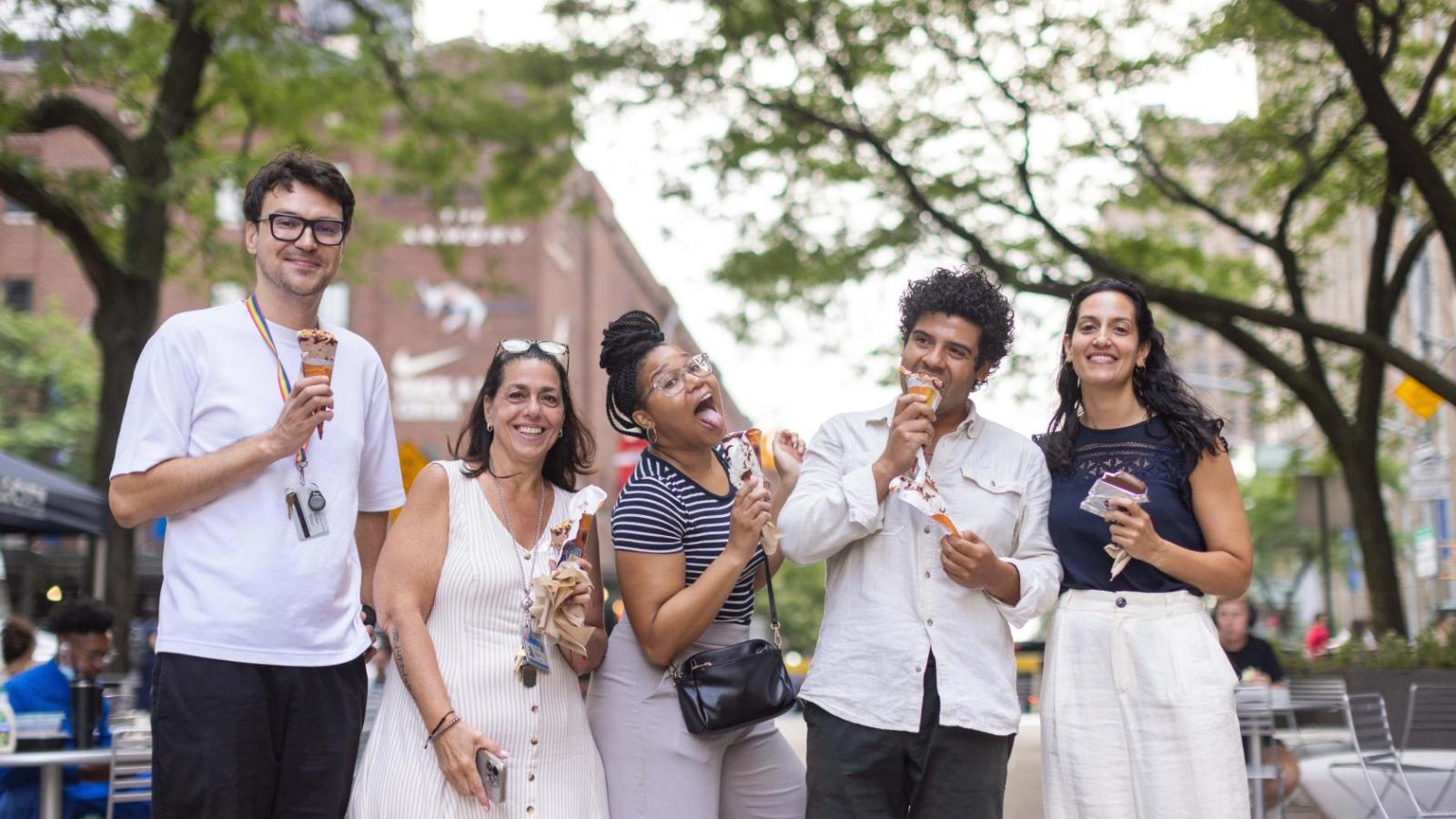 A group of people pose for the camera with ice cream in their hands
