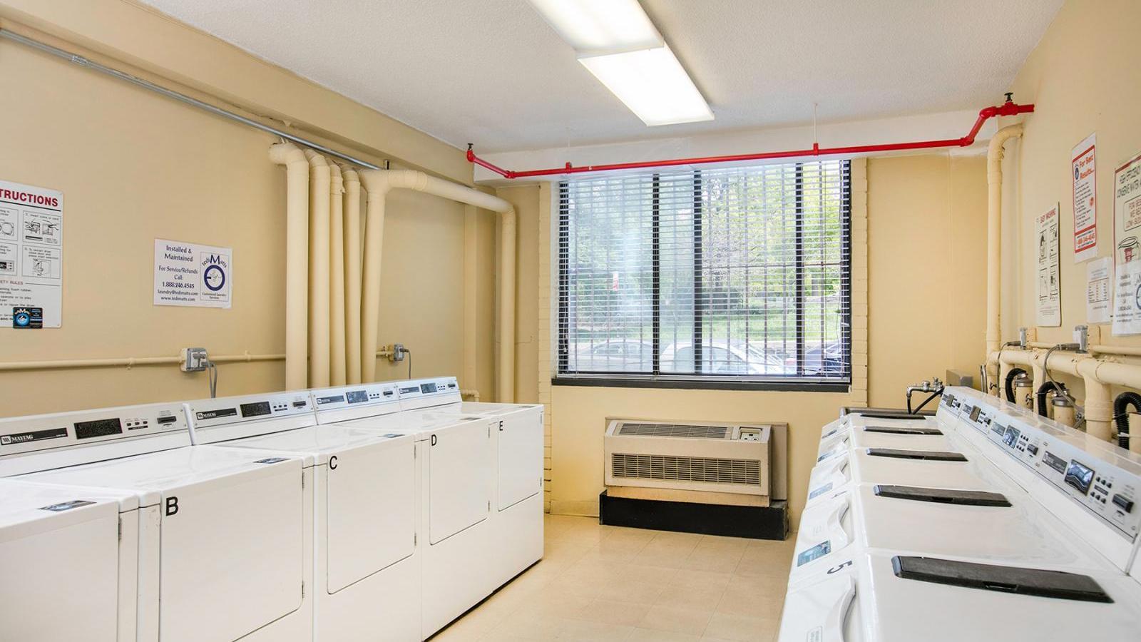 Laundry room showing multiple washers an dryers.