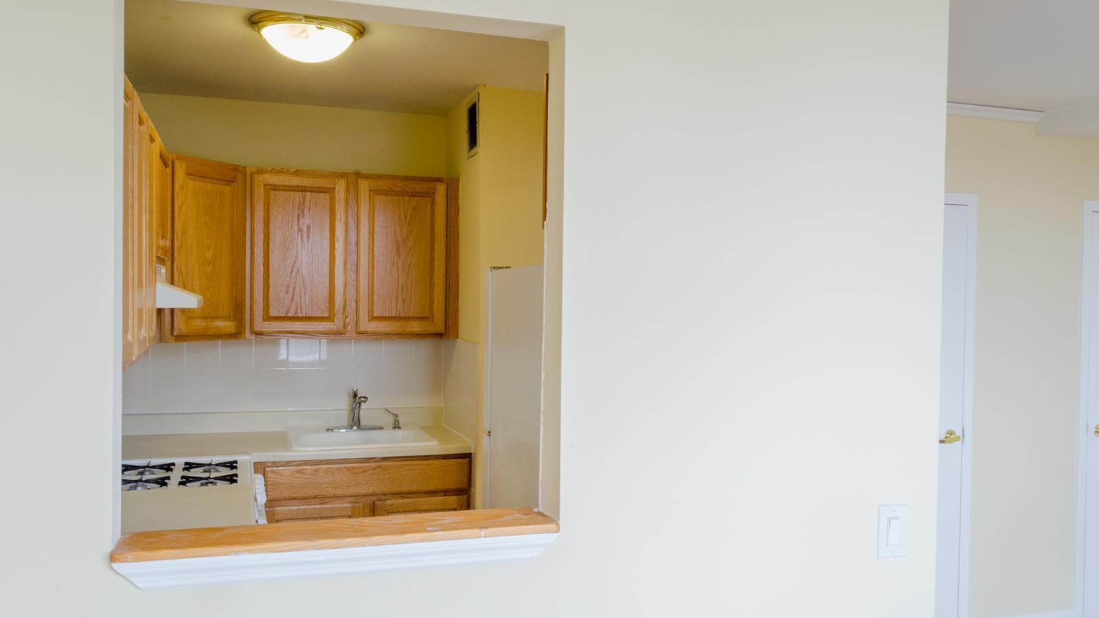 Sample one-bedroom kitchen in 390 Fort Washington, shown through the kitchen opening.
