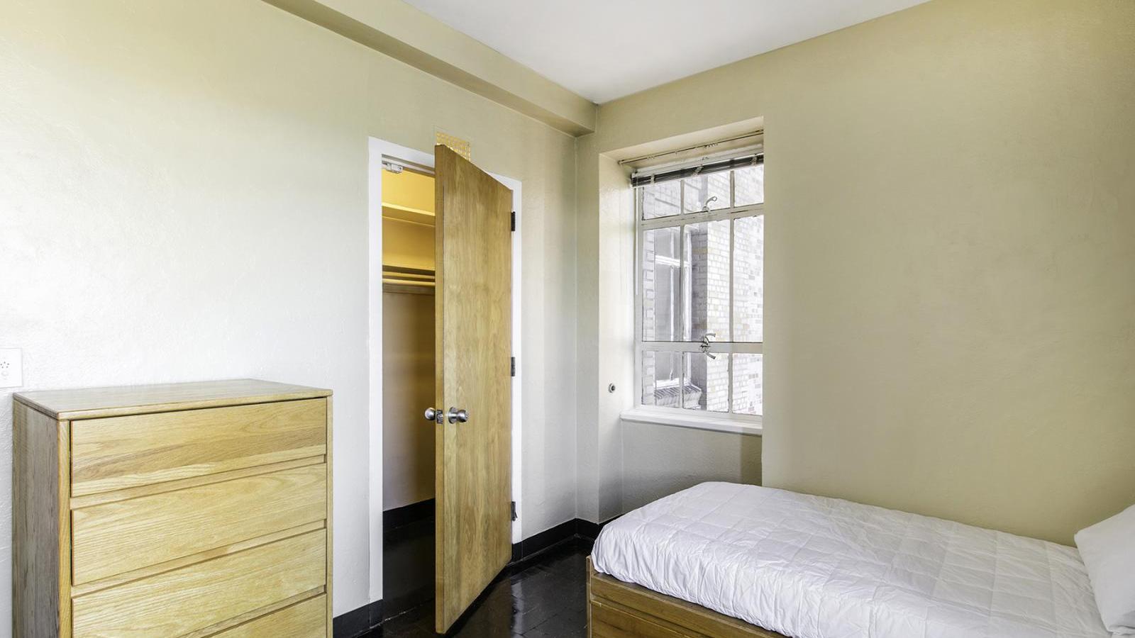 View of a sample dormitory-style bedroom in 50 Haven Avenue (Bard Hall), showing the closet.