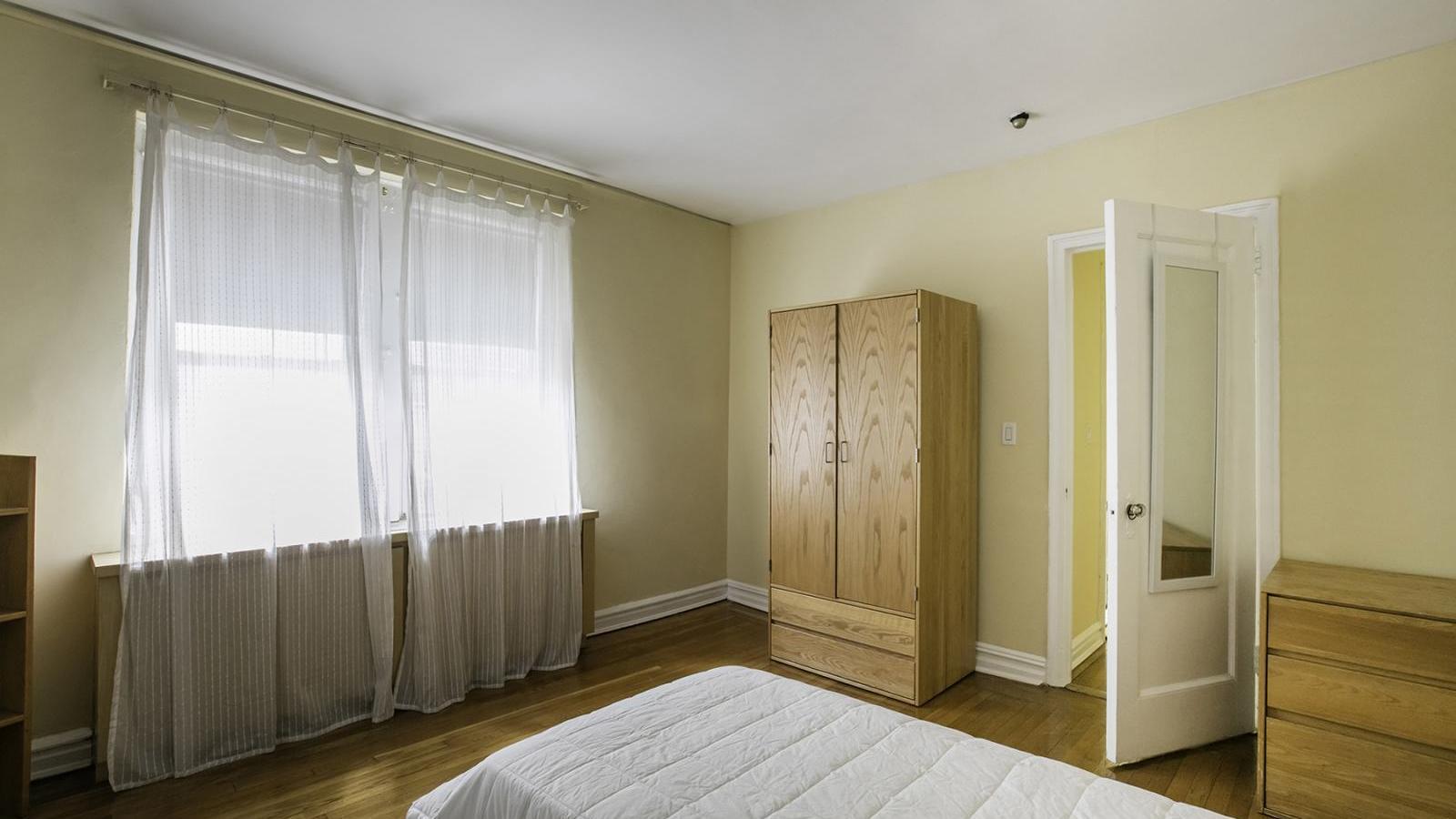 View of a sample bedroom in a railroaded apartment in the Georgian Residence.