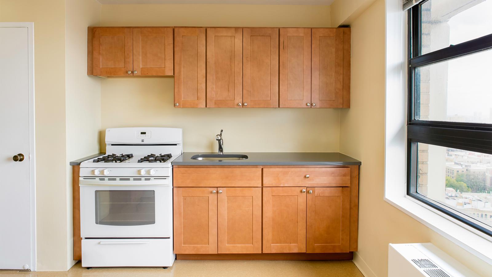 View of a sample kitchen in an “A” Apartment (29A) in Tower 1, view 1.