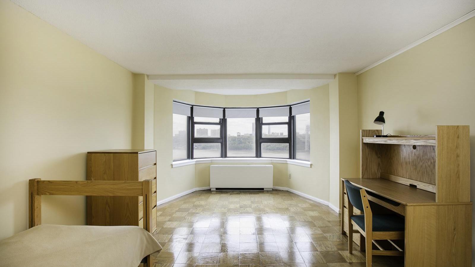 View of a sample furnished room (14H) in Tower 3, showing a bay-window view of the river.