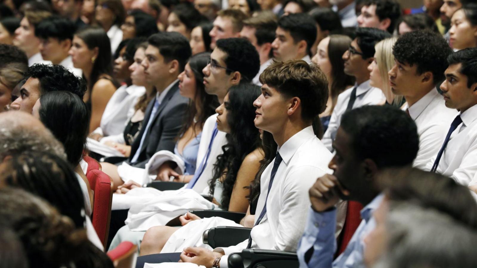 dozens of students sitting in auditorium