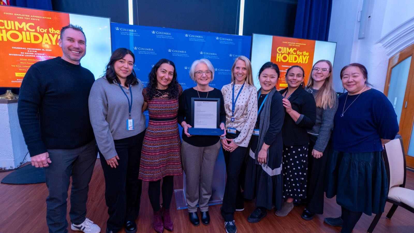 baton award winner with work colleagues