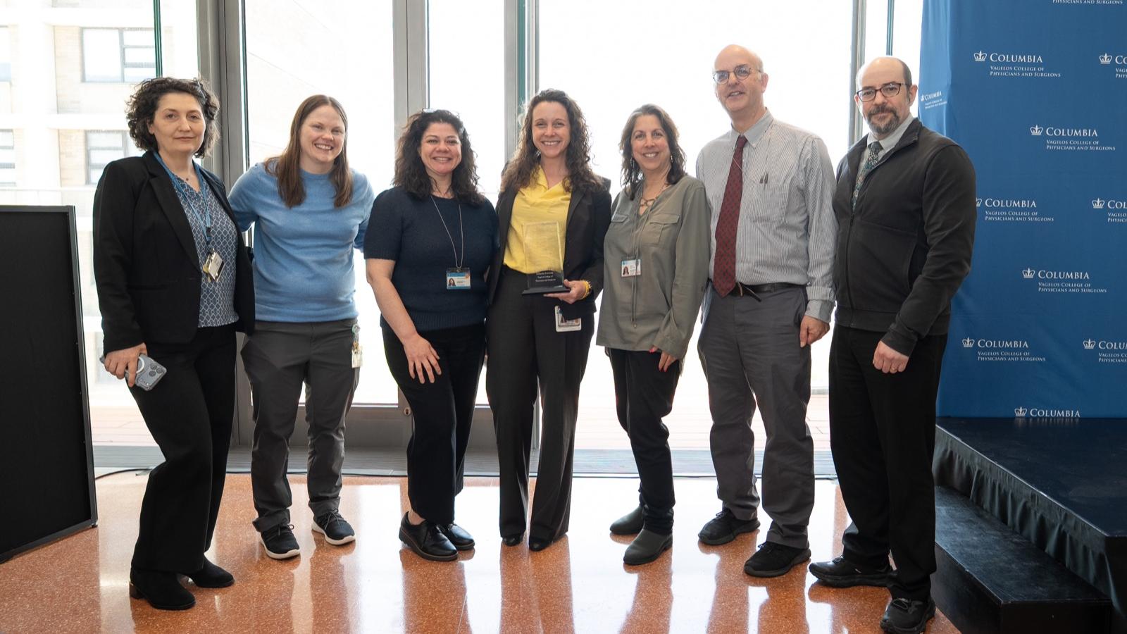 Hooven award winner standing with colleagues