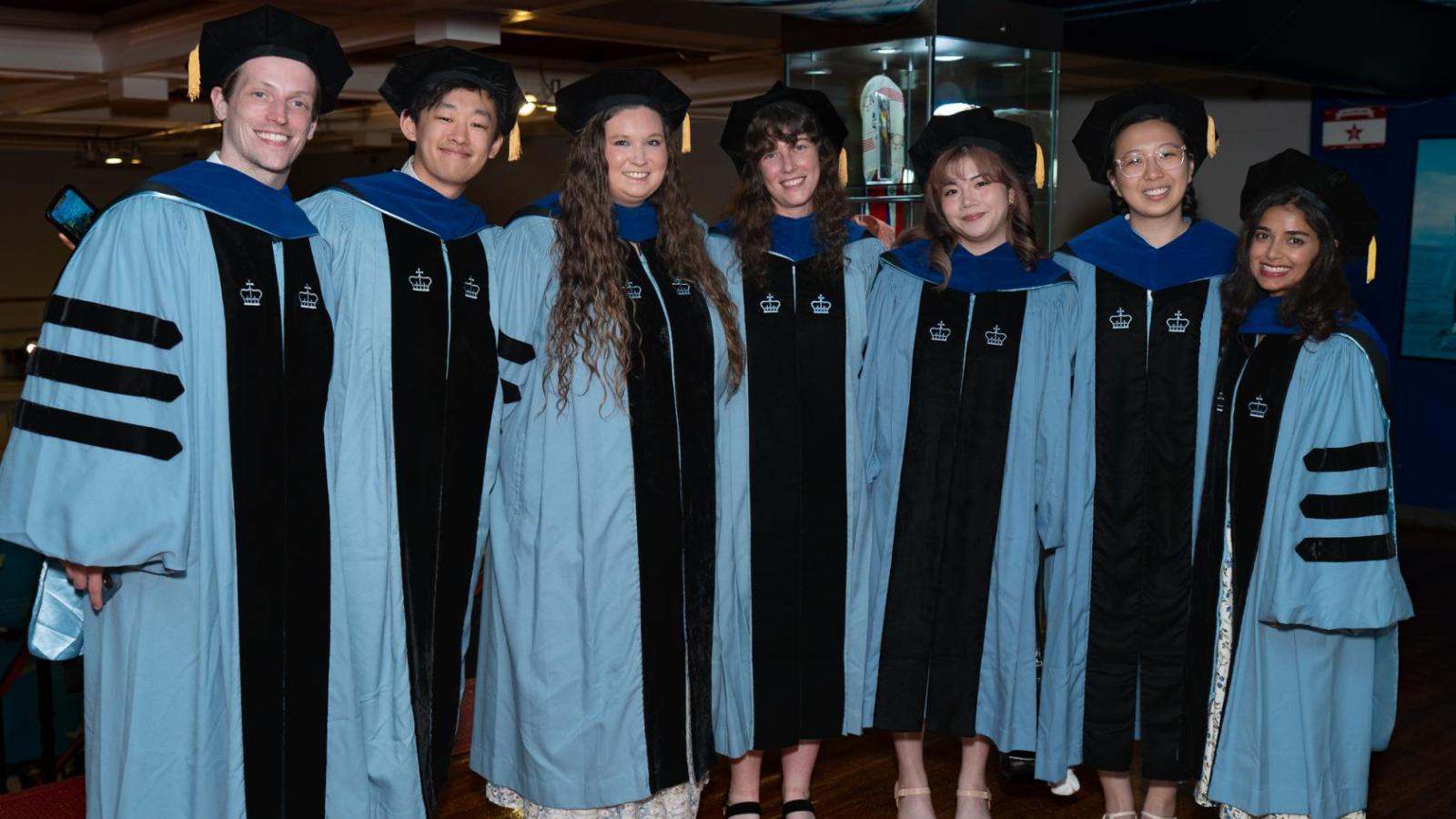 PhD graduates in their academic robes