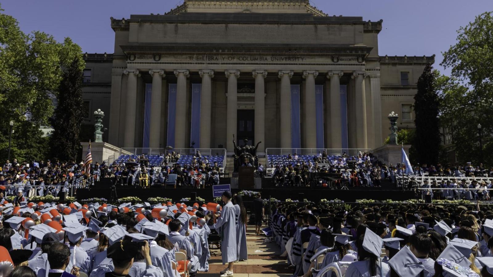 hundreds of graduates in front of Columbia's Low Library during commencement