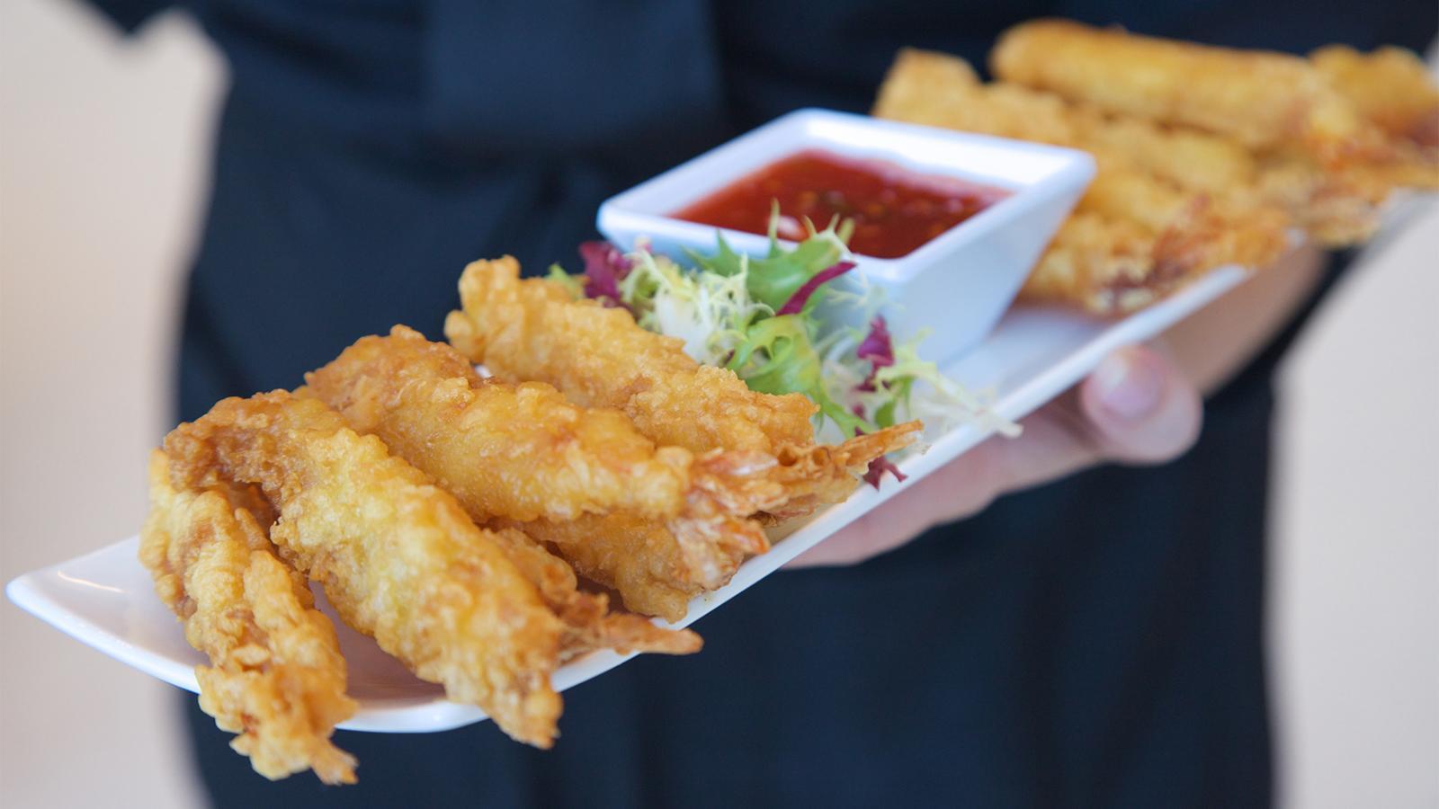Shrimp tempura being served as hors d'oeuvres at a reception