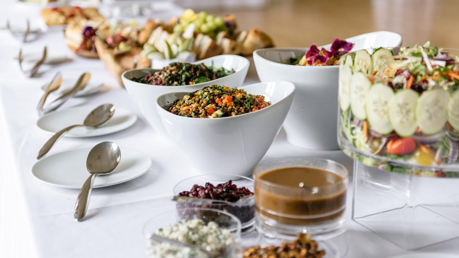 A table with place settings and menus tucked in napkins