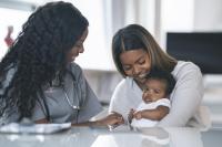 mother holding baby at a doctor's visit