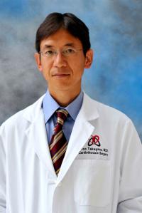 Surgeon Hiroo Takayama wearing his white doctor's coat and facing the camera