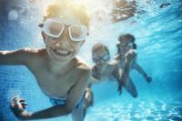 kids swimming underwater in a pool