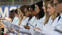 Columbia medical students at white coat ceremony reciting Hippocratic oath