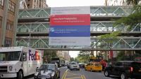 NewYork-Presbyterian pedestrian bridge over street, with signs