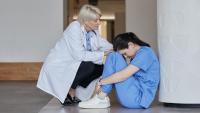 A doctor consoling a nurse.