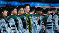medical students wearing academic robes during their graduation ceremony